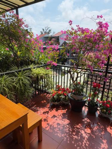 a balcony with a bunch of plants and flowers at Tue Tam Garden Villa in Hoi An
