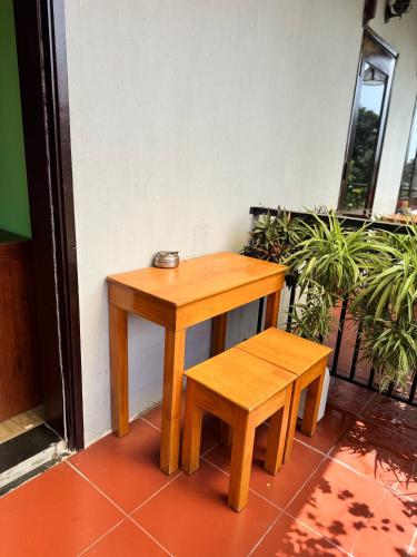 a small wooden table and bench next to a building at Tue Tam Garden Villa in Hoi An