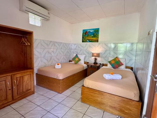 Postel nebo postele na pokoji v ubytování Sari Bungalows