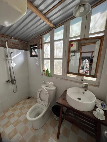 a bathroom with a toilet and a sink at MAMA's House Mộc Châu in Mộc Châu
