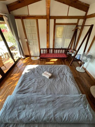 a bedroom with a large bed in a room with windows at MAMA's House Mộc Châu in Mộc Châu