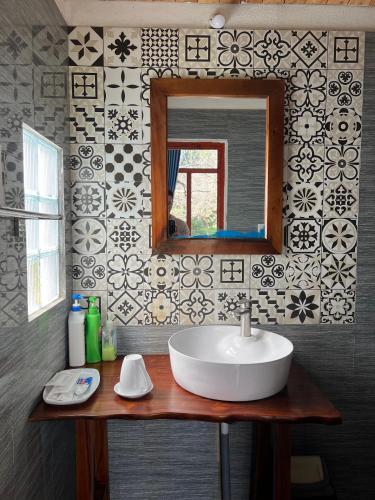 a bathroom with a sink and a mirror at MAMA's House Mộc Châu in Mộc Châu