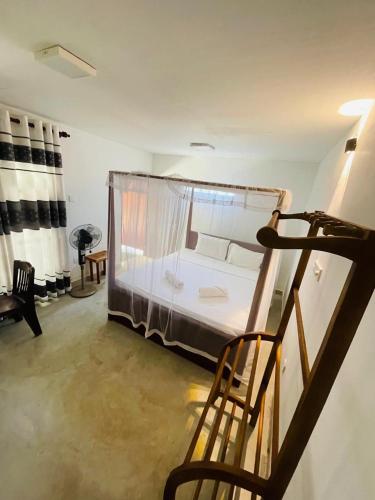 a bedroom with a bed with a mosquito net at Lagoon view resort in Ahangama