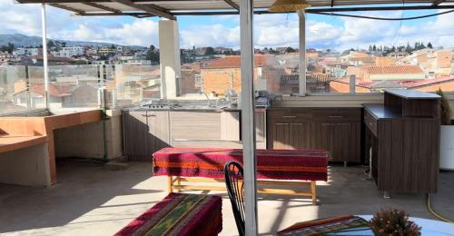 a kitchen with a table and a view of a city at Hotel Las Americas in Cuenca