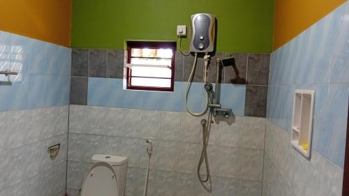 a bathroom with a shower with a toilet and a camera at Nest hostel negombo in Negombo
