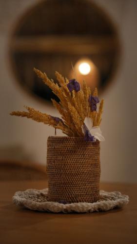 a small vase with flowers in it on a table at AMAN Villas & SPA in Gili Air