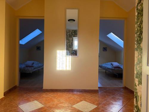 a room with two beds and a hallway with skylights at Dom całoroczny, Krzeszna in Krzeszna