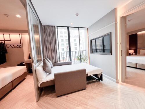 a room with two beds and a mirror at The Quarter Ploenchit by UHG in Bangkok