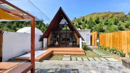 a house with a thatched roof on a patio at Heavenly 1 - Private Triangle in Bandung