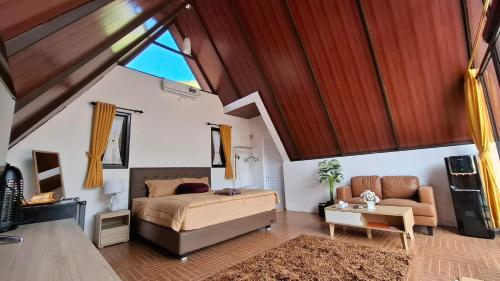 a bedroom with a bed and a couch and a table at Heavenly 1 - Private Triangle in Bandung