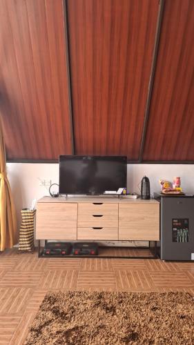 a flat screen tv sitting on top of a wooden entertainment center at Heavenly 1 - Private Triangle in Bandung