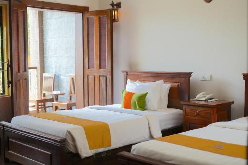 a hotel room with two beds and a window at Hello Cambodia Boutique in Siem Reap