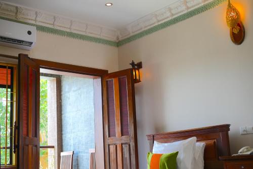 a bedroom with a bed and a window at Hello Cambodia Boutique in Siem Reap