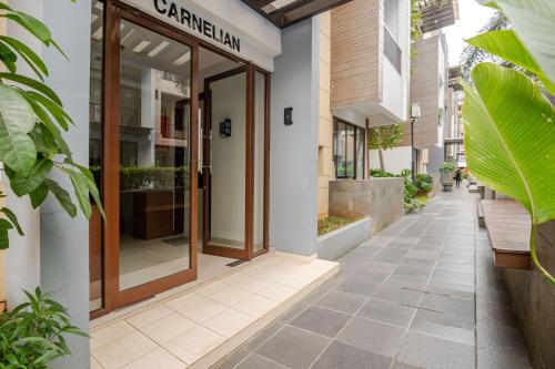 a building with a glass door on a street at 2BR Serviced Apartment at Vanya Park Asatti Garden BSD City in Tangerang