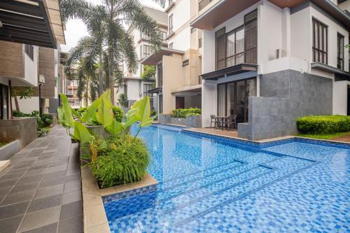a swimming pool in front of a building at 2BR Serviced Apartment at Vanya Park Asatti Garden BSD City in Tangerang
