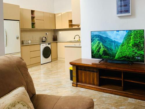 a living room with a large flat screen tv at Beverly Edge Villa in Sri Jayewardenepura Kotte