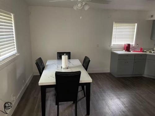 a kitchen with a table with chairs and a candle on it at Lovely One Bedroom Apartment in Merrillville