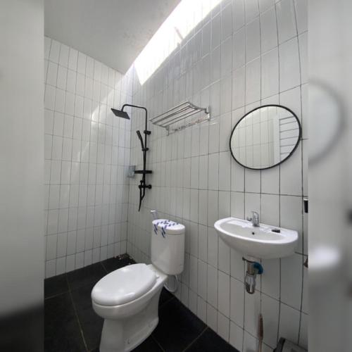 a bathroom with a toilet and a sink at Heavenly 2 - Private Triangle in Bandung