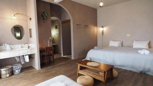 a hotel room with a large bed and a sink at 宮古島の自然豊かで静かなエリアroom0オリジナルインテリア小物が溢れる空間 in Miyako Island