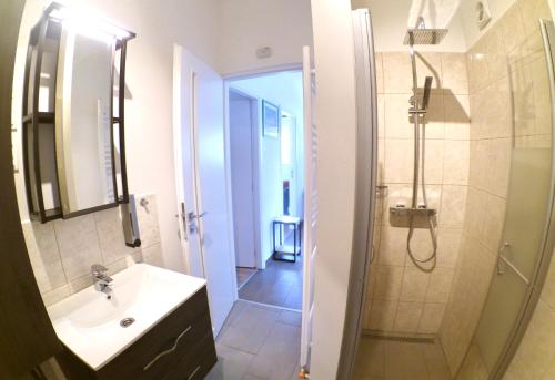 a bathroom with a sink and a shower and a sink at Quiet, green, relaxing place - 2 bedroom apartment in Balatonfüred