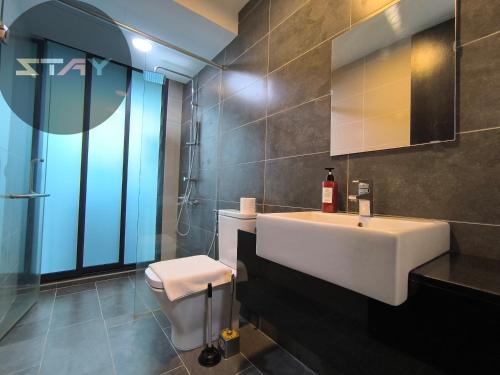 a bathroom with a white sink and a toilet at Almas Warm N Comfy 2Pax Puteri Harbour BySTAY in Nusajaya