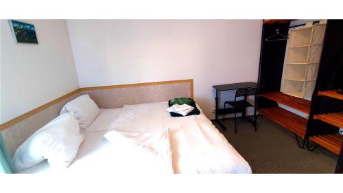 a bedroom with a bed with a bag on it at Pension Helene s mini pivovarem in Kytlice