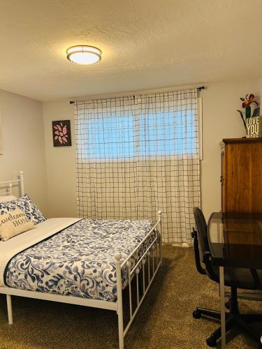 a bedroom with a bed and a desk and a window at Emerald City 3 Bedroom 1 bath Home in Eugene