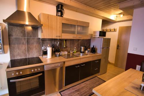 a kitchen with a sink and a stove at Huber's Lodge in Hainzenberg