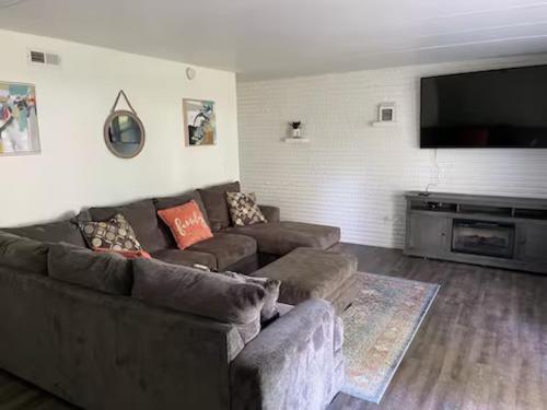 a living room with a couch and a flat screen tv at Lovely One Bedroom Apartment in Merrillville