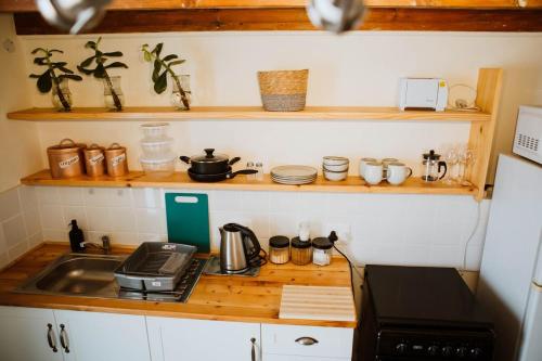 a small kitchen with a sink and a stove at The Loft House in Graaff-Reinet