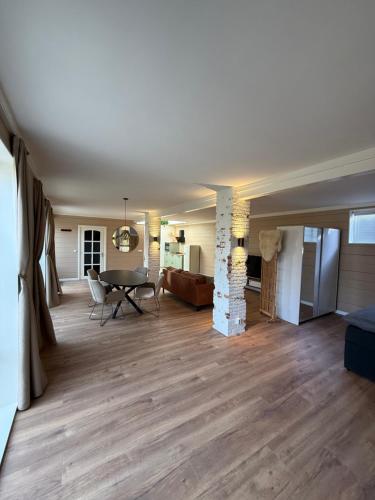 a living room with a table and a couch at Spacious 70m2 apartment in city centre with lovely terrace in Alkmaar