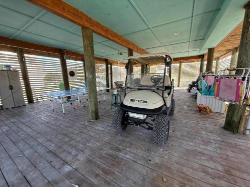 a golf cart parked in a room with a table at Family Tides on LGI - Golf Cart Included in Placida
