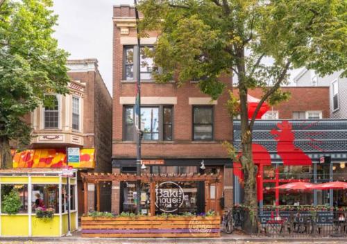 a building with a restaurant with red umbrellas on a street at The Roscoe Village Guesthouse in Chicago