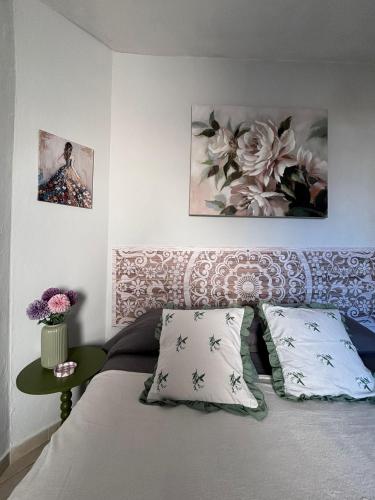 a bedroom with a bed with two pillows and a table at Un piede nel Chianti in Cavriglia