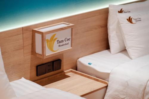 a room with two beds and a box on the wall at Tam Coc Wonderland Lodge in Ninh Binh