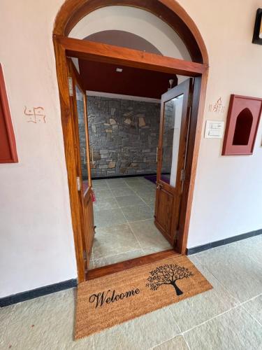 an open door in a room with a tile floor at EcoMinimalist Home by the River in Seringapatam