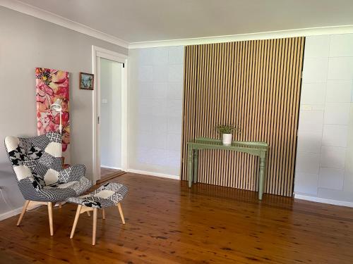 a living room with two chairs and a table at Garden View Entire Self Contained Guesthouse in Engadine