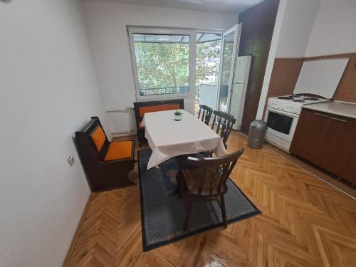 a kitchen with a table and chairs in a room at Dramski apartment in Skopje