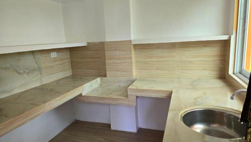a small kitchen with a sink and a counter at Eagle's Nest Inn in Cabangusan
