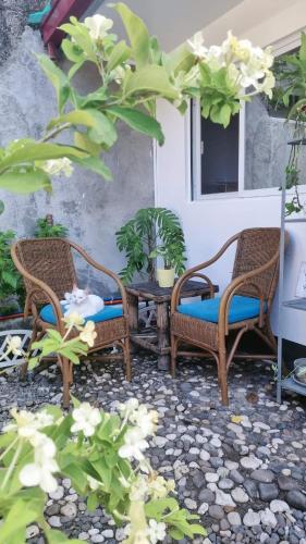 two wicker chairs and a table on a patio at Matabungkay staycation in Batangas for 5pax in Lian