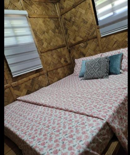 a large bed in a room with two windows at Matabungkay staycation in Batangas for 5pax in Lian