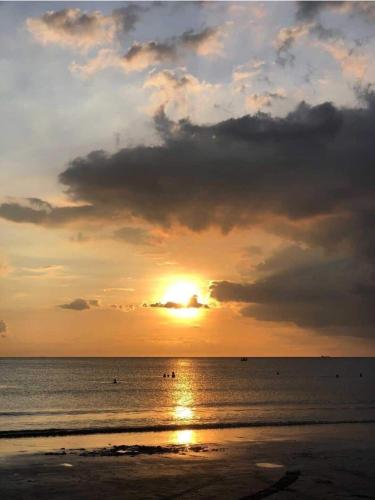 a sunset on the beach with the sun setting at Matabungkay staycation in Batangas for 5pax in Lian