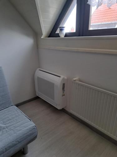 a small room with a heater and a window at Apartment Oase in Balatonszemes