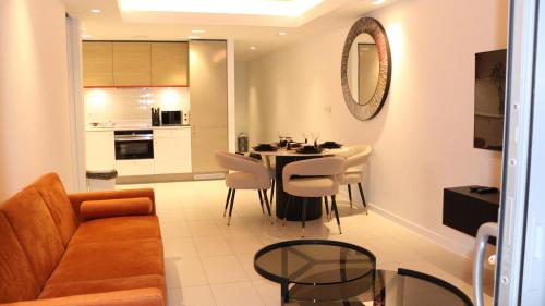 a living room with a couch and a table and chairs at Luxury 1 Bedroom Apartment In London with Free parking in London
