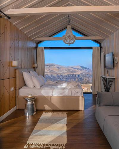 a bedroom with a bed and a large window at Shakaryan Rancho&Restaurant in Dsegh