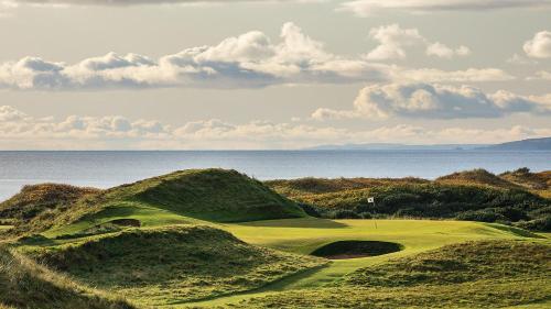 a golf course with the ocean in the background at West Coast Home From Home in Stevenston