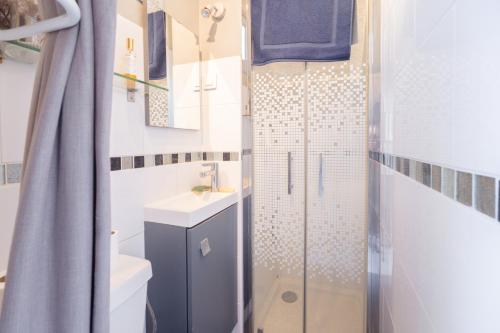 a bathroom with a shower with a sink and a toilet at Le Terra'Ciel - Ciotat in La Ciotat