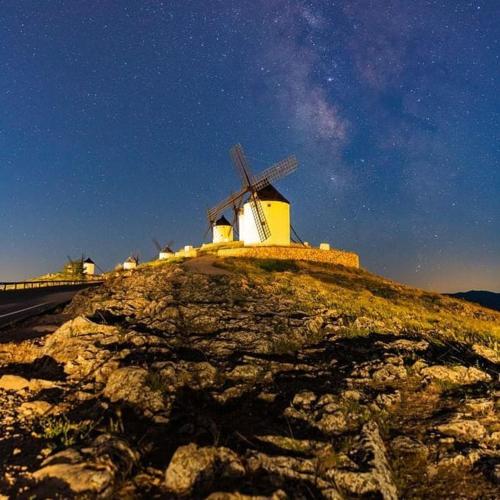 a windmill on top of a hill at night at El Patio de los Jazmines Boutique-House in Consuegra