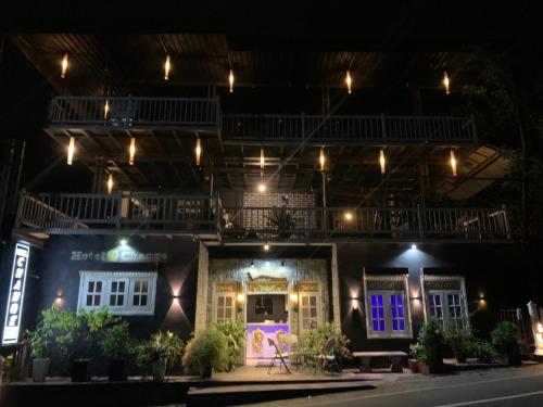 a house with purple and blue doors at night at Hotel Change in Badulla