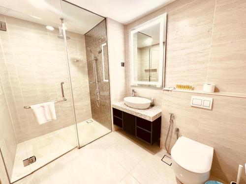a bathroom with a shower and a toilet and a sink at Star Residence Suite KLCC in Kuala Lumpur